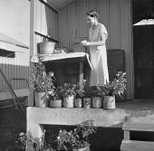 Camp member on the porch of her shelter