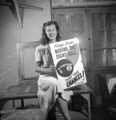 Young woman posing with a completed safety poster at the NYA's Camp Roosevelt - Ocala, Florida.