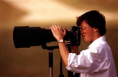 Photographer for the Tallahassee Democrat posing with camera.
