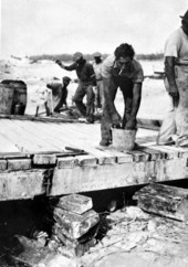 Relief worker bathing hands after handling the body of a dead veteran