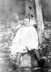 Herbert L. Drew receiving a haircut