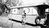 People standing outside Colonel Manning's house trailer that he built
