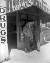 Arthur William Morrison with a friend outside his drugstore - Miami, Florida.