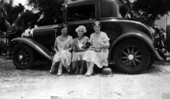 Old women sitting on the edge of a car - Miami, Florida.