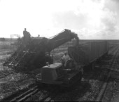 View of workers using agricultural machinery.