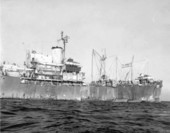 U.S.S. Dade (ATA-99) unloading troops on landing craft