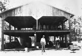William E. Marchant standing in front of his turpentine still with his son Oren - Newberry, Florida