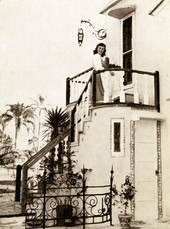 Employee on staircase with beverages at Chalet Suzanne in Lake Wales, Florida.