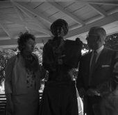 Man and woman standing by statue