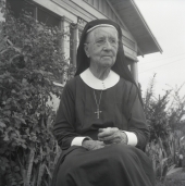Deaconess Harriet Bedell sitting in front of the Glade Cross Mission