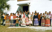 Group portrait of Seminole Indians in front of the Indian Baptist Church