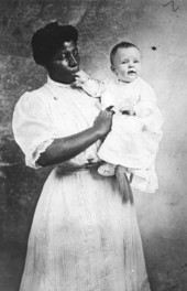 African American nursemaid and an infant