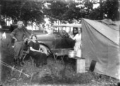 Man, two women, a tent and a poodle