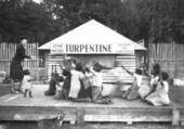 Woman and children on stage at turpentine plant in Brooksville, Florida.