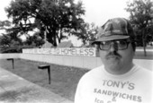 Gene Slomenski in front of tents