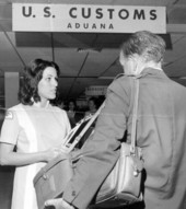 Elena Bravo helps a passenger in the Customs area