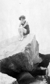 Althea Estell Ford sitting on big rock.