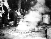 Sheriffs destroying distillery equipment.