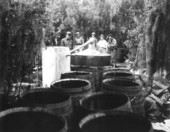 Sheriffs destroying distillery equipment.