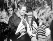 Lee Majors and Burt Reynolds signing autographs.