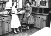 Kathleen Rich and Mrs. Floyd Fogle standing in a kitchen