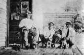 Men on porch with dogs - Tallahassee, Florida.