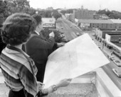 Two people reading a map - Tallahassee, Florida.