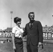 Burt Reynolds with citrus queen at garnet and gold football game.