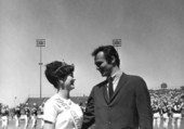 Burt Reynolds with citrus queen at garnet and gold football game.
