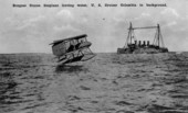 Burgess Dunne seaplane leaving water, U.S. Cruiser Columbia in background..