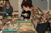 Senate Committee chair Nancy Argenziano examining pottery fragments at Mission San Luis during tour - Tallahassee, Florida.