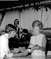 1969 Florida Teacher of the Year Barbara Goldman, left, and Florida Development Commission employee June Murphy looking at informational pamphlet at the Florida Showcase in New York.