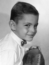 Portrait of Mike Norman, Jr. with a football.
