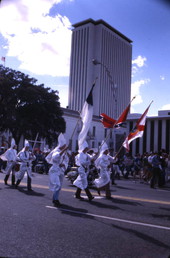 KKK members marching north on South Monroe Street during a rally in front of the Capitol building - Tallahassee, Florida.
