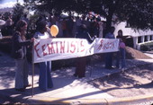 Feminists against racism holding up a banner at a KKK rally on South Monroe Street in Tallahassee, Florida.