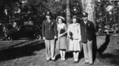 Portrait of two newly wedded couples at Dale Mabry Field near Tallahassee, Florida.