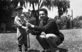 LeRoy Collins Junior in a baseball uniform holding a bat with Dan McCarty.