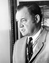 Florida Governor Claude Kirk wearing a microphone.