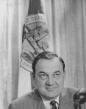 Florida Governor Claude Kirk in front of the Florida state flag.