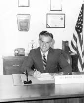 Florida legislator Wayne Mixson doing paperwork at his desk.