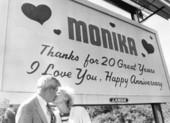 Florida senator George Kirkpatrick kissing his wife, Monika, under a billboard - Tallahassee, Florida