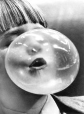 Boy blowing a bubble with bubblegum