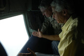 Governor Charlie Crist with Florida National Guard Adjutant General Douglas Burnett looking out from the U.S. Air Force turboprop airplane used to transport them during Tropical Storm Fay.