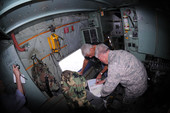 Governor Charlie Crist conferring with Florida National Guard Adjutant General Douglas Burnett aboard the U.S. Air Force turboprop airplane used to transport them during Tropical Storm Fay.