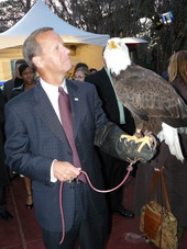 Florida Atlantic University President Frank Brogan meeting an American bald eagle from Sea World at an outdoor cocktail party before the legislative session in Tallahassee, Florida.