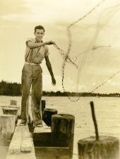 Unidentified young man casting net for mullet - Riviera Beach, Florida.