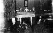 Women sitting by fireplace holding their musical instruments - Tallahassee, Florida.