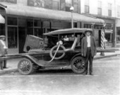 Revenue agent James E. Bowdoin with confiscated moonshine still
