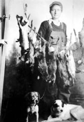 Woman and dogs with hunted rabbits - Jefferson County, Florida