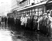 Crowds gathered in the rain by street cars - Jacksonville, Florida.